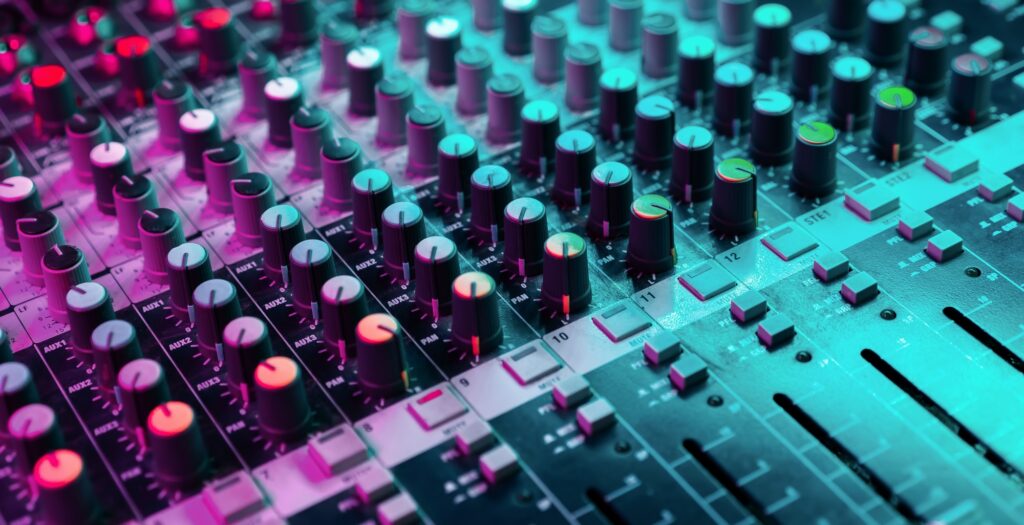 Close up of sound mixing console. Details of sound engineer room. Neon light